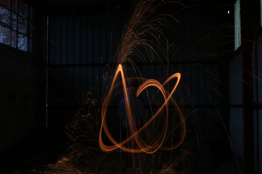 steel wool photography, man performing fire dancing, orange, blue