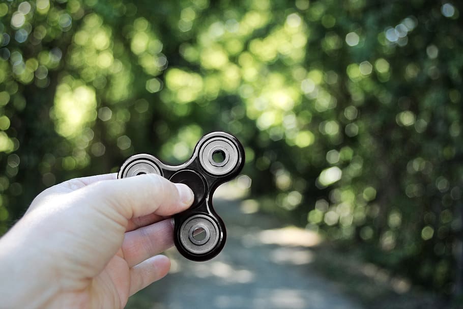 fidget spinner, toys, hand, bokeh, human hand, human body part HD wallpaper