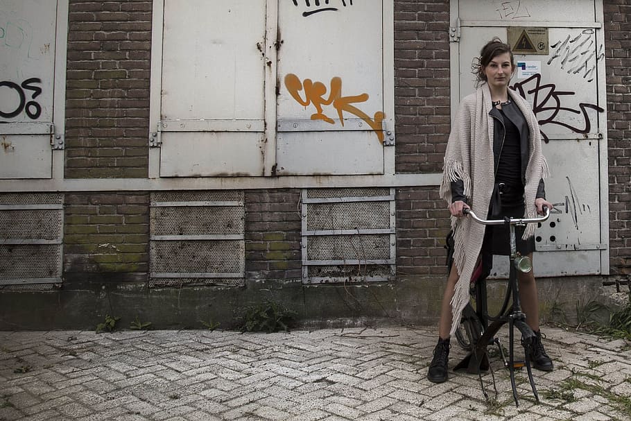 woman wearing gray fringed scarf riding bicycle, Graffiti, Girl