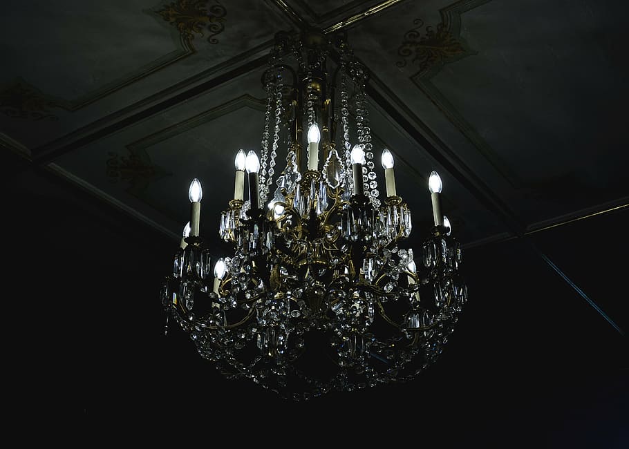 clear uplight chandelier on gray ceiling, dark, decoration, glass