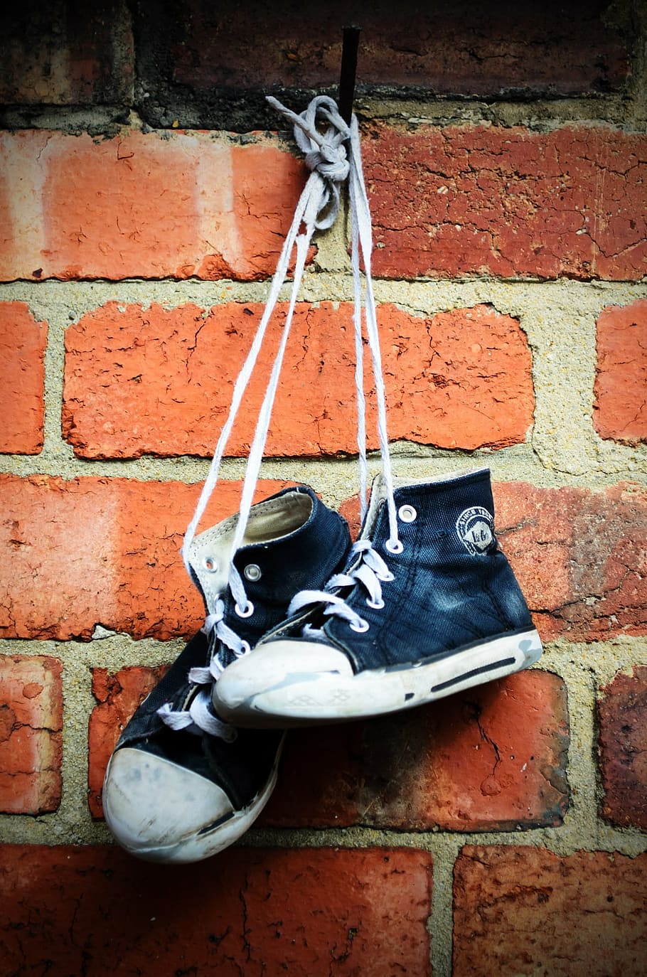 pair of sneakers hanging on brick wall, shoes, boots, old, children