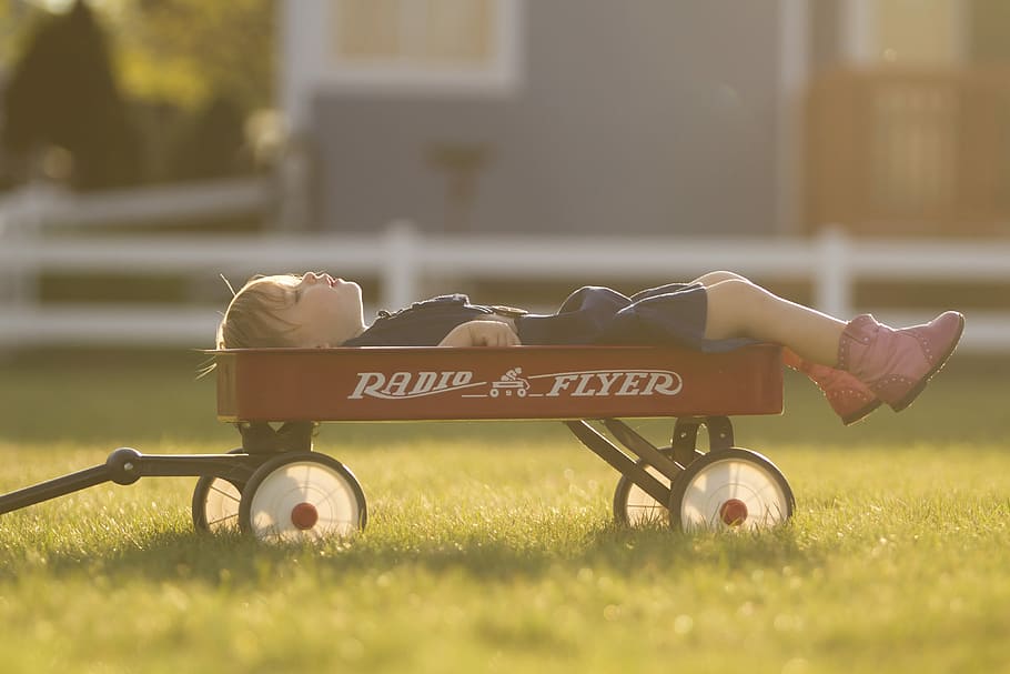 So I Guess This is What Two Feels Like, boy laying on red wagon