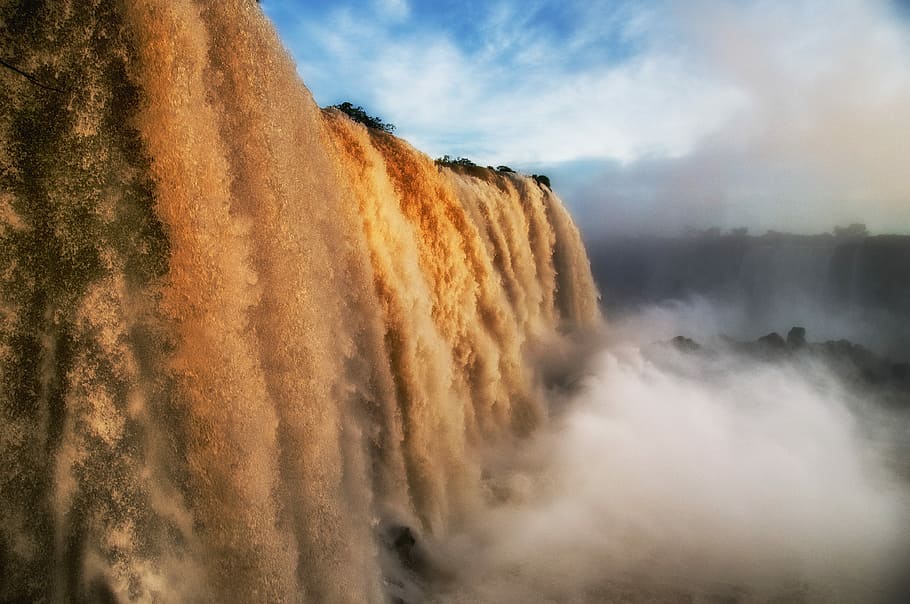 waterfall under cloudy sky, waterfalls, sunset, light, nature HD wallpaper