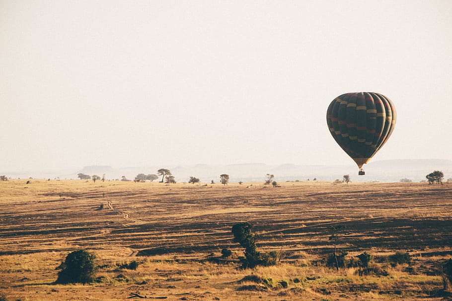 brown hot air balloon during dayime, air balloon floating above desert, HD wallpaper