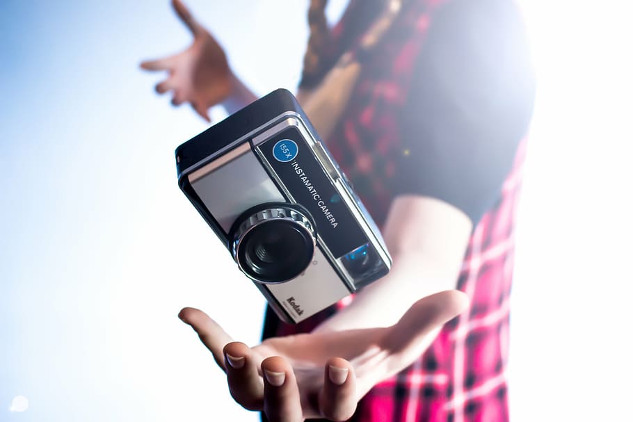 person about to catch black Kodak camera, hand, palm, photography HD wallpaper