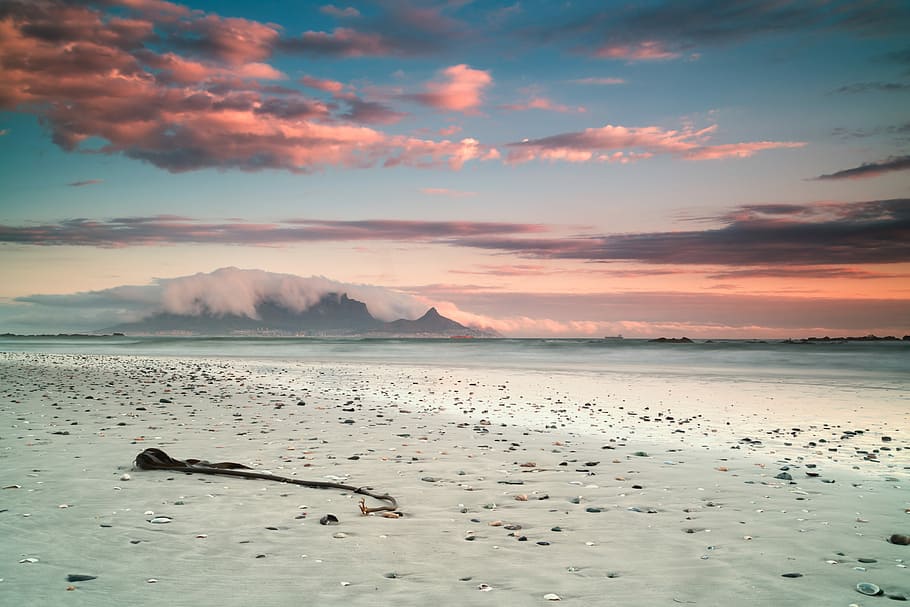 landscape photography of seashore under cloudy sky, seashore under blue and sky during daytime HD wallpaper