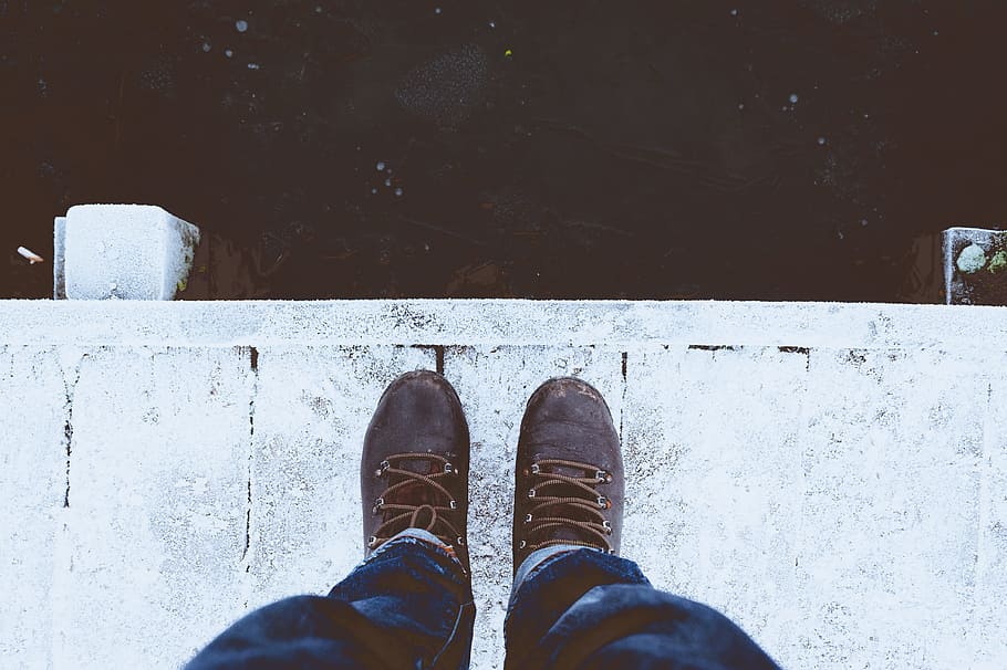 person standing white floor, person wearing blue denim jeans and brown boots standing on white wooden dock HD wallpaper
