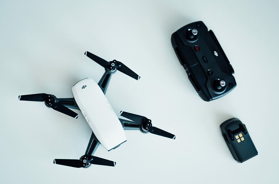 white and black quadcopter drone on white table, DJI Mavic drone near remote HD wallpaper
