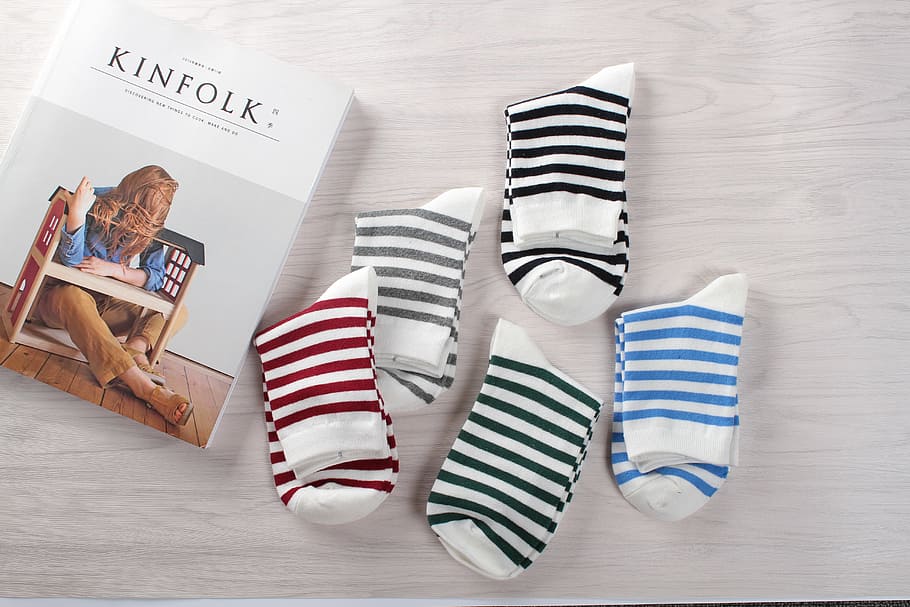 five pairs of assorted-color stripe socks near box, colored socks