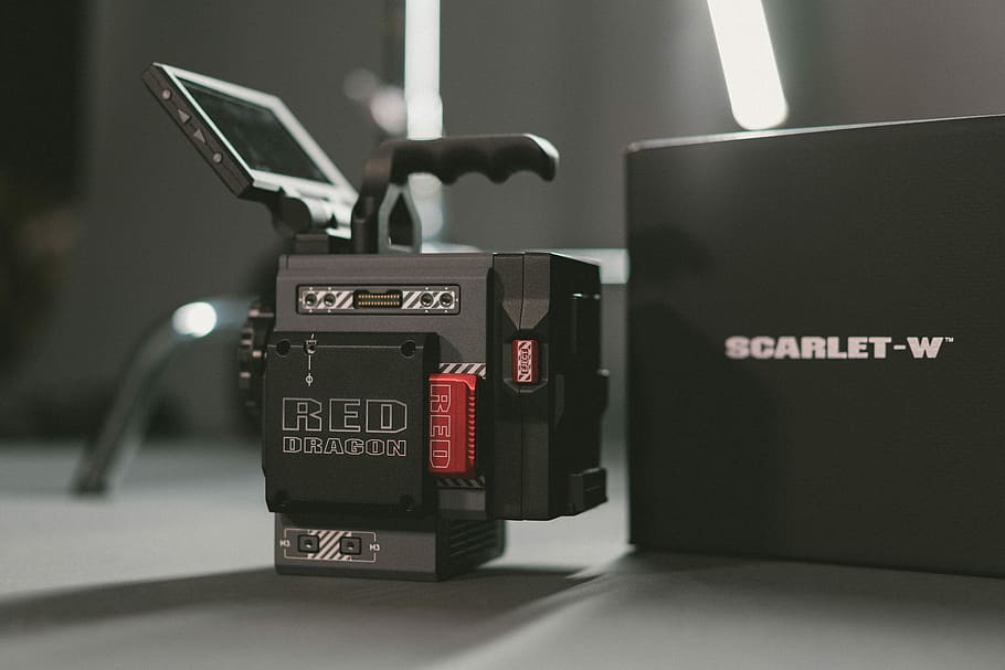 close-up photography of Red Scarlet-W camera with box, selective focus photo of black and gray Scarlet-W device beside box HD wallpaper