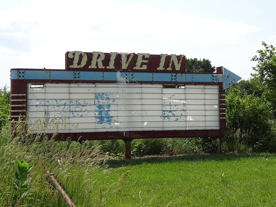 drive-in theater sign, abandoned, horizontal plane, small town