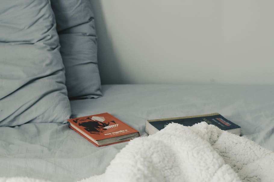 two novel books on bed, two assorted-title books on bed, pillow HD wallpaper
