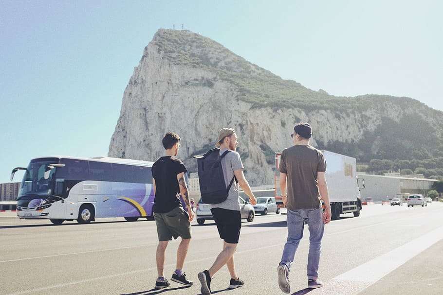 three men walking on street near vehicles during daytime, three men walking on park HD wallpaper