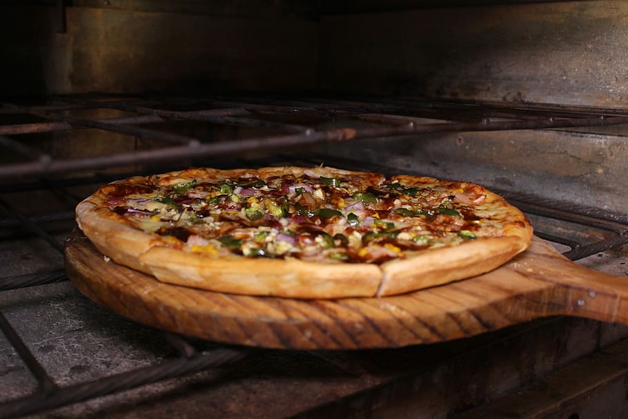 baked pizza on brown wooden pizza pan putting on oven, food HD wallpaper