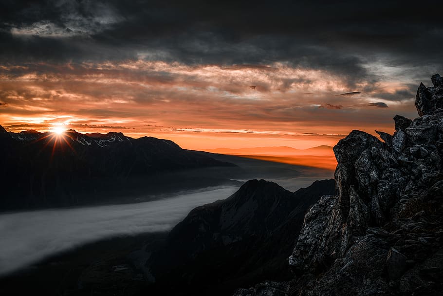 high angle photography of mountain range under nimbus clouds, bird's eye view photography of mountain with fogs HD wallpaper