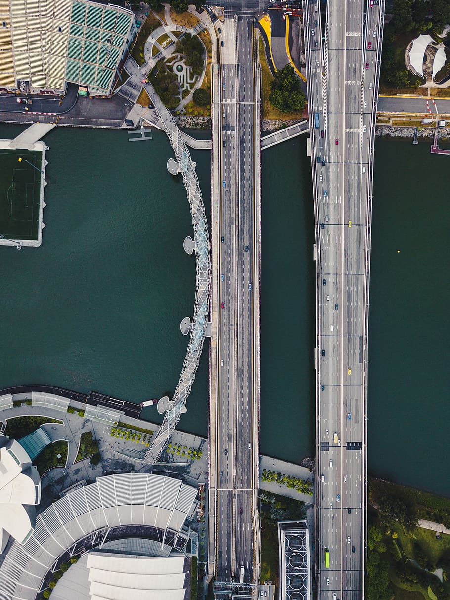 aerial photography of two gray suspension bridge and buildings during daytime, bird's eye view of two gray bridge HD wallpaper
