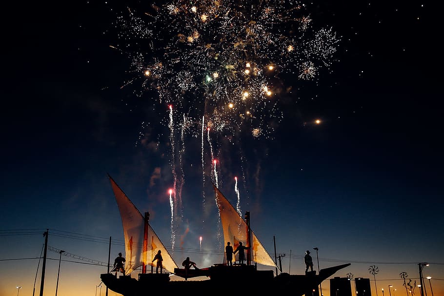 silhouette photography of person standing while watching fireworks in the sky, silhouette of people on boat watching fireworks display HD wallpaper