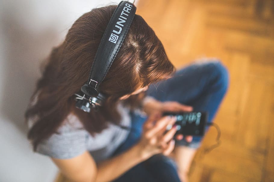 woman wearing headphones while holding phone, music, listening