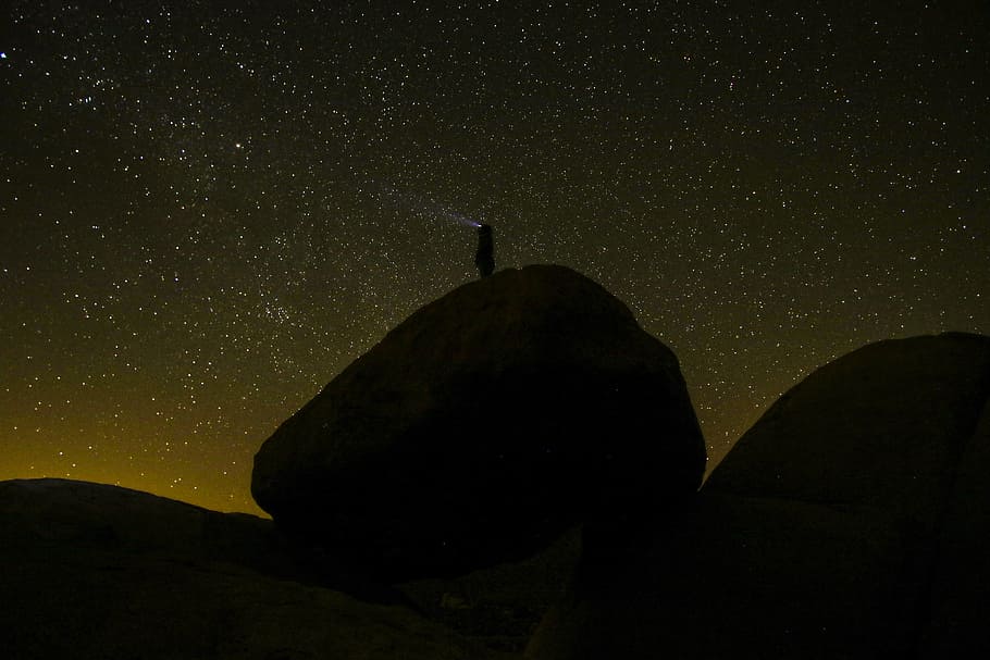 silhouette of rock, silhouette of person on rock formation during nighttime HD wallpaper
