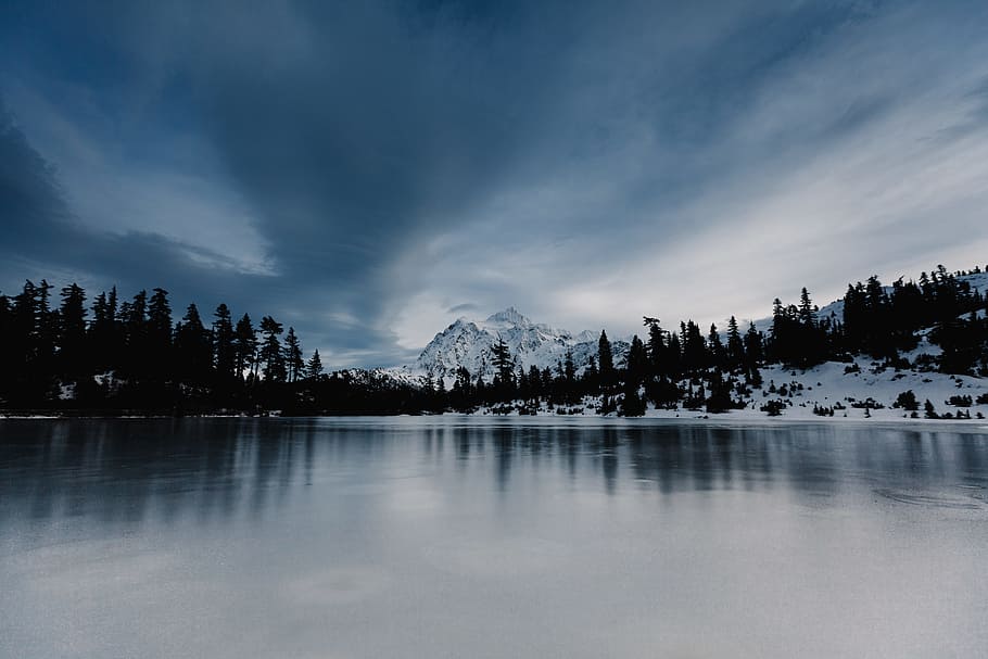 overlooking view of mountain under nimbus clouds, body of water surrounded of trees HD wallpaper