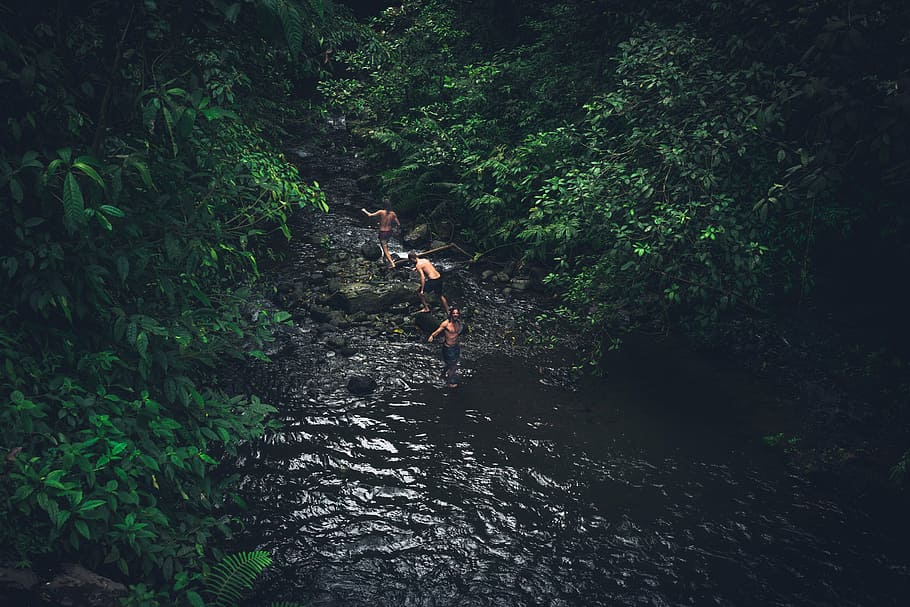 bird's eye-view photography of three person near the water stream HD wallpaper