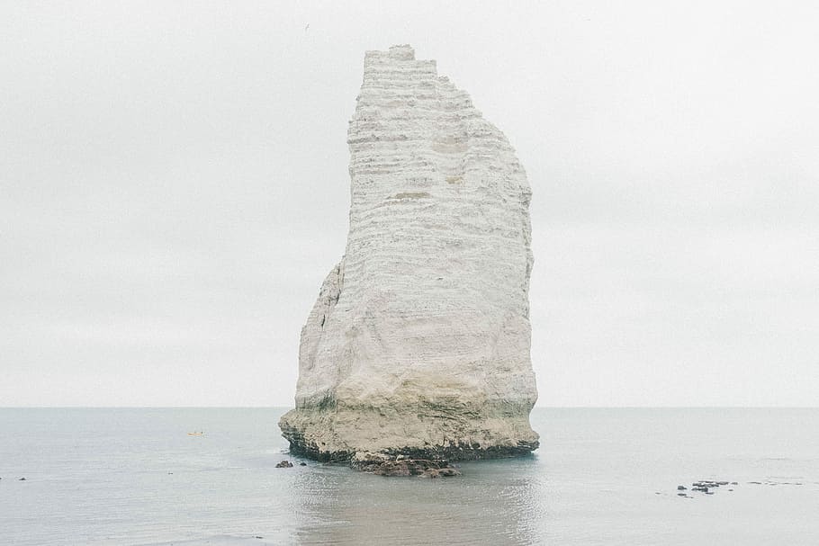 white stone formation in the middle of the sea, gray rock formation on body of water HD wallpaper