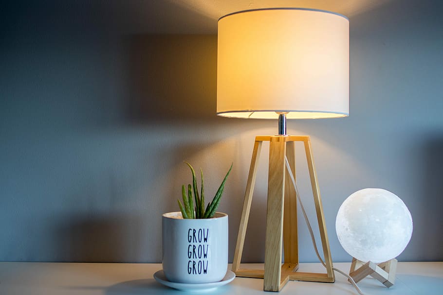 brown and white table lamp with light, brown wooden base desk lamp