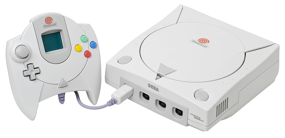 white Sega Dreamcast console with controller, Video Game Console