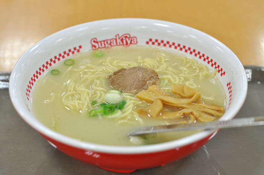  Bowl of spicy miso ramen topped with pork and vegetables