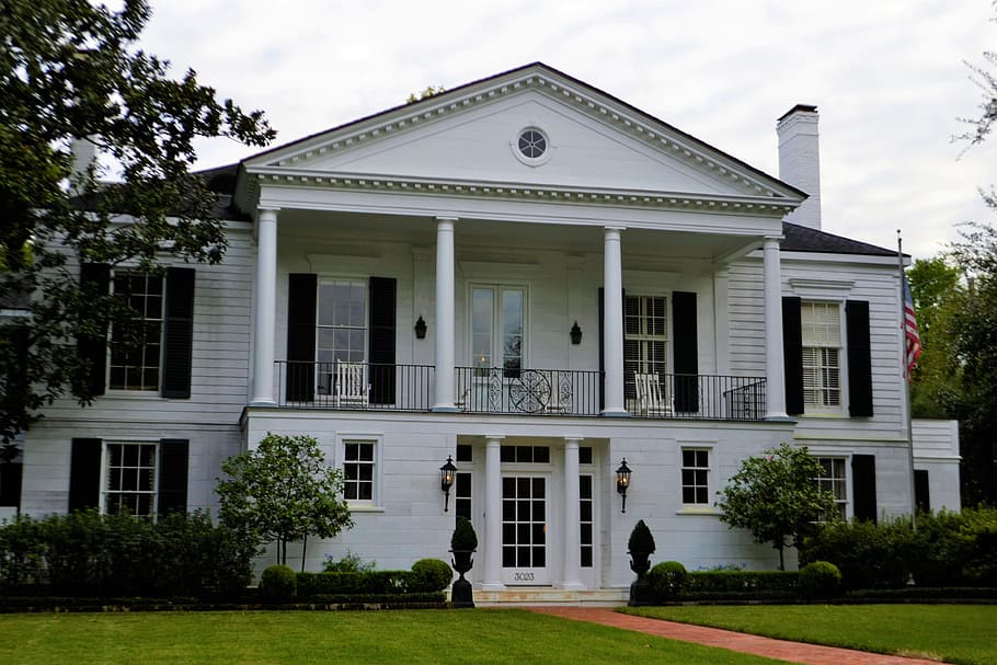 white house beside trees, river oak home, houston, texas, luxury home