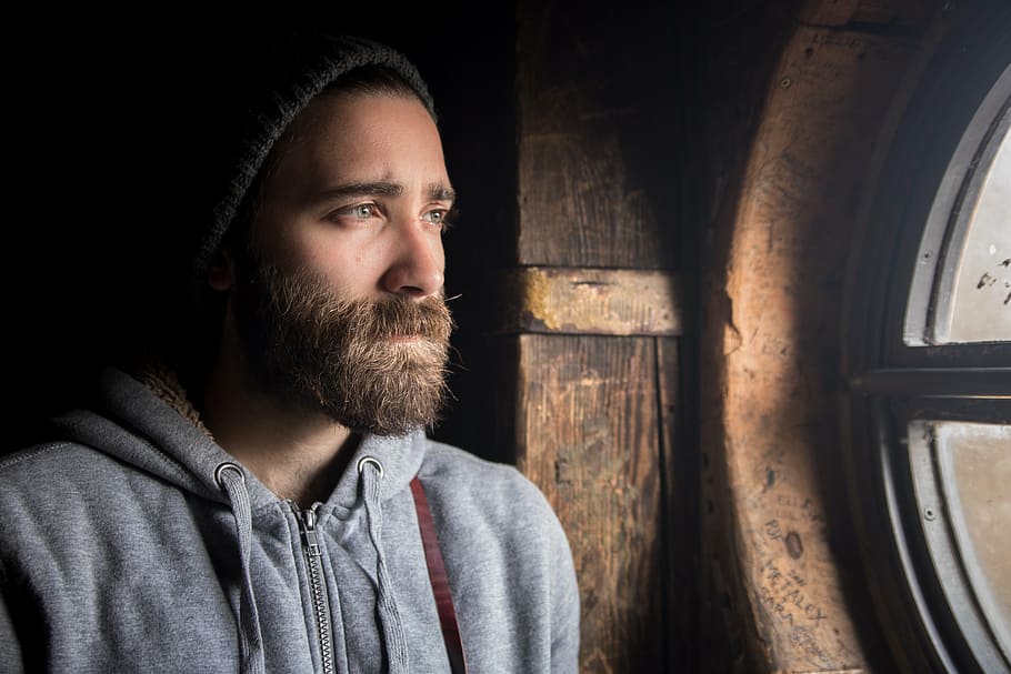 man standing behind the window, beanie, guy, beard, jacket HD wallpaper