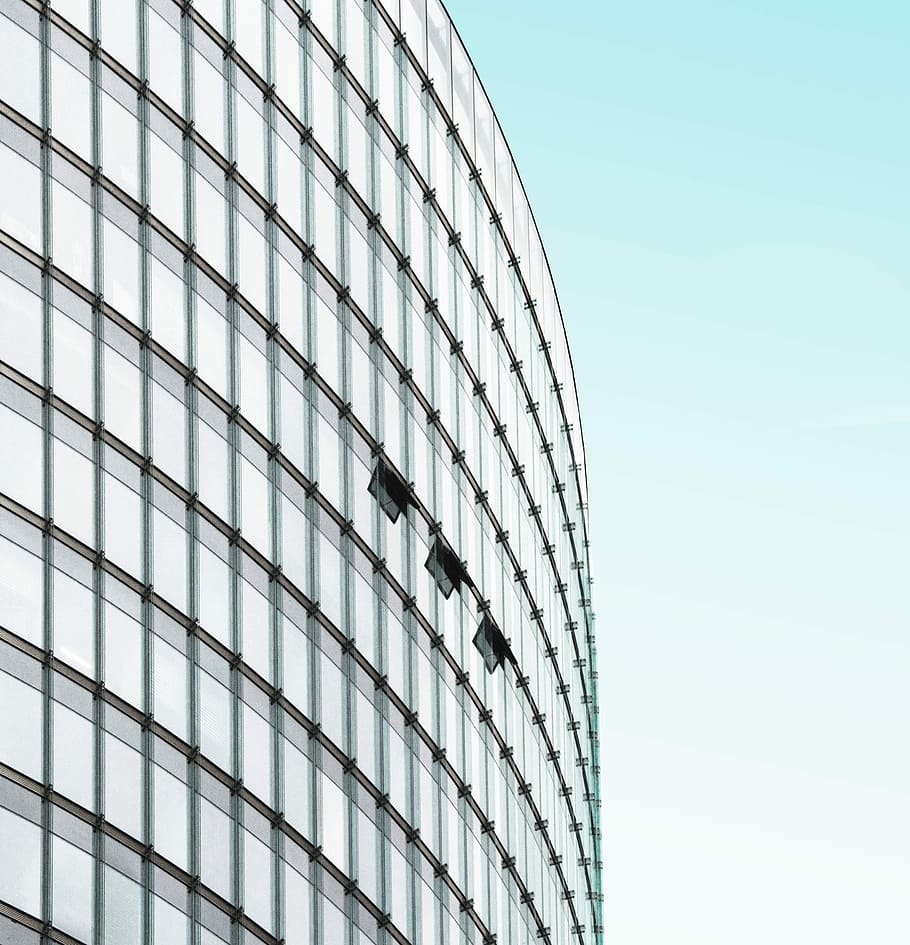 low-angle photography of building under clear blue sky, glass high-rise building under clear blue sky during daytime HD wallpaper