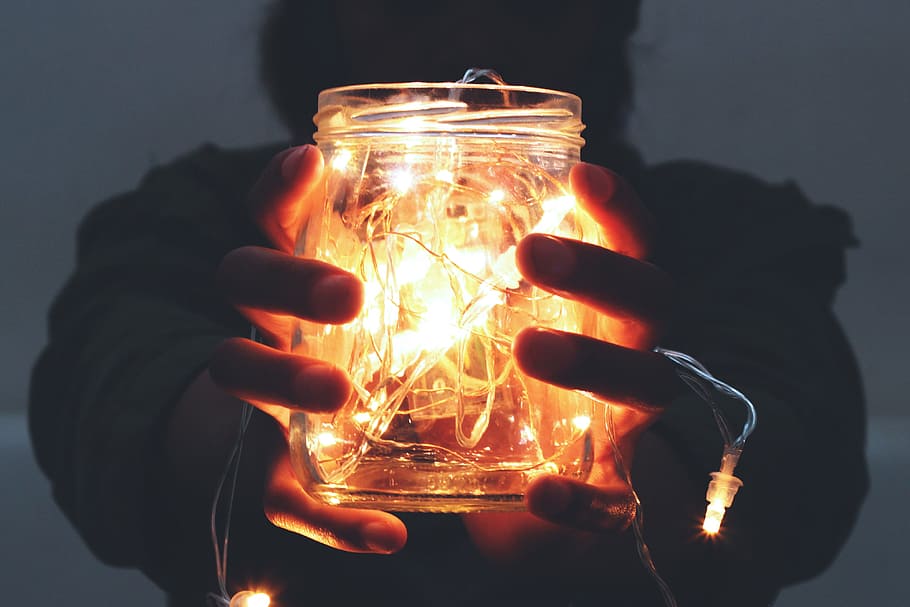 Man holding lights in a jar, people, fire - Natural Phenomenon