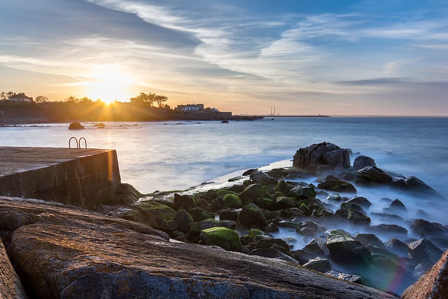 rock formation near body of water, photo of beach under blue sky at sunset HD wallpaper
