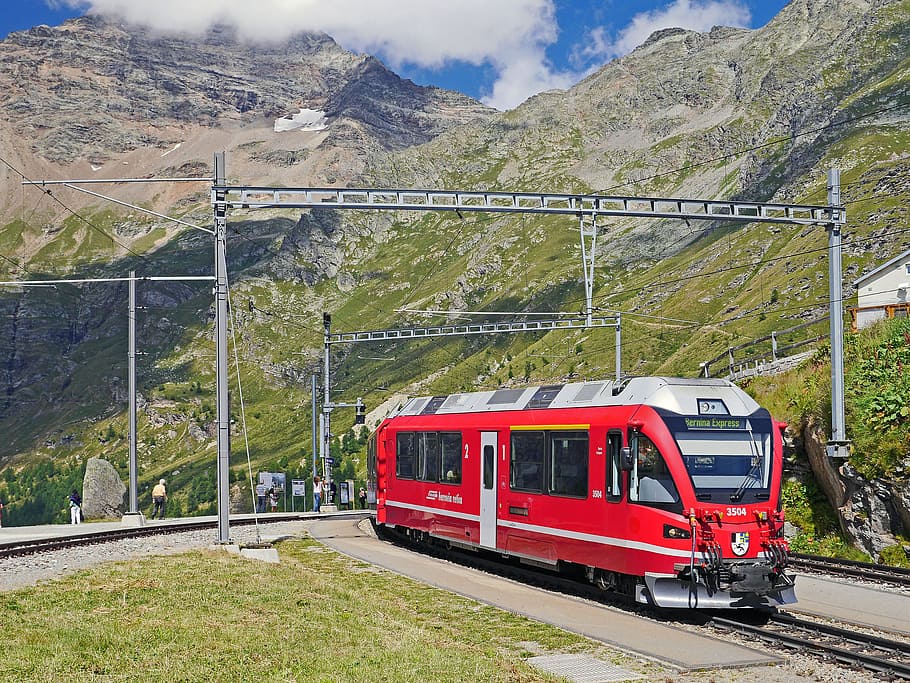 red and gray train in rail near mountain, bernina-express, alp grüm