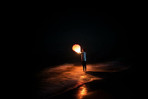 person holding paper lantern against black background, night HD wallpaper