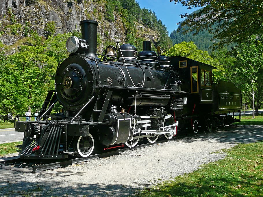 black and gray train on black rail during daytime, locomotive