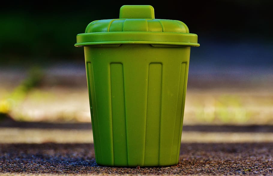 selective focus photography of green plastic container on brown surface