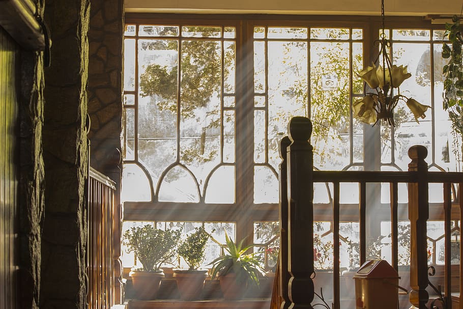brown wooden balustrade with light filtering through glass windows in background during daytime HD wallpaper