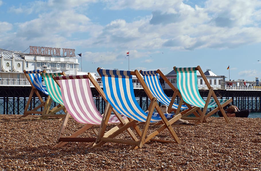 empty chairs near body of water, sun loungers, beach, deck chair