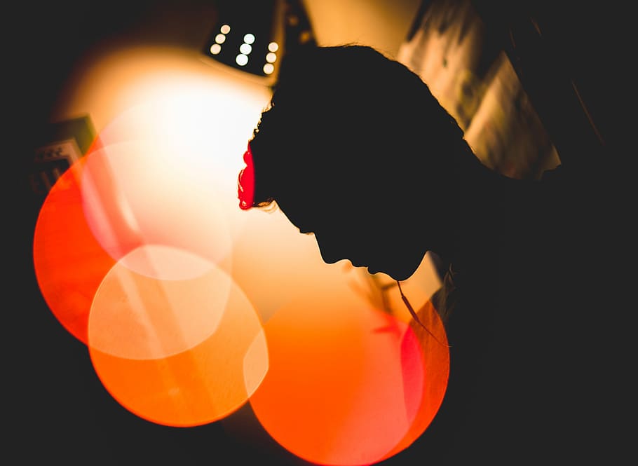 bokeh photography of silhouette of man leaning on wall, silhouette of man HD wallpaper