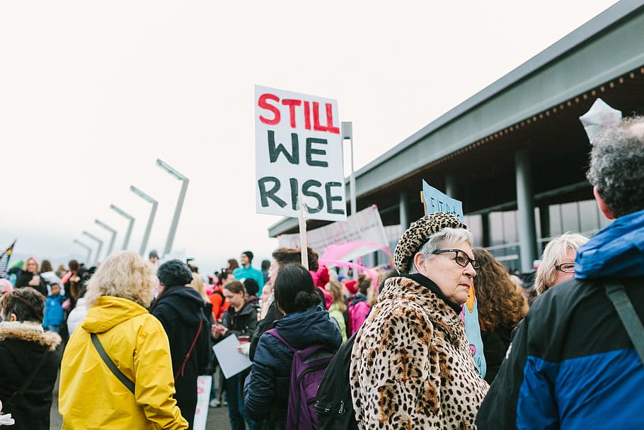 woman holding still we rise banner, people, crowd, rally, protest HD wallpaper