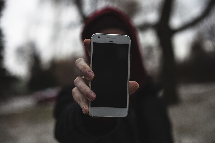 tilt-shift lens photography of person holding smartphone close to camera, woman holding very silver Google Pixel smartphone HD wallpaper