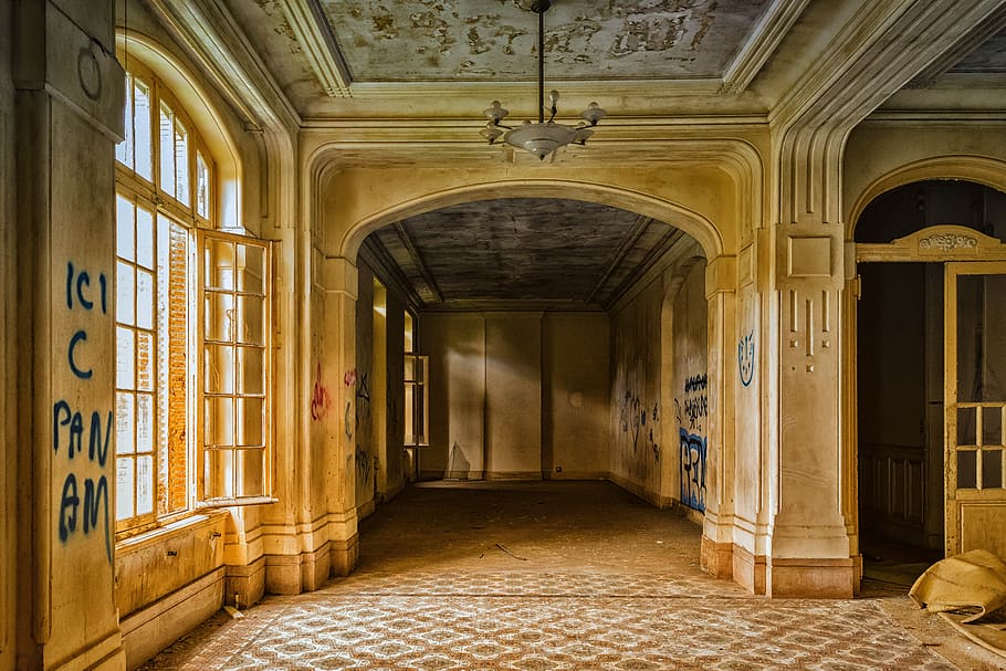 photo of brown and beige house interior with windows, lost places