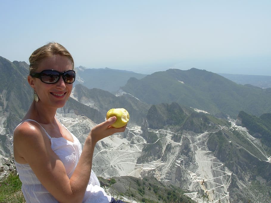 woman holding apple on top of mountain, marble, carrara, smile, HD wallpaper