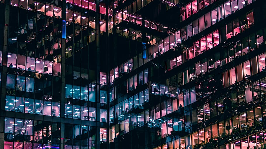 architectural photography of building with people in it during nighttime, lighted high rise building HD wallpaper