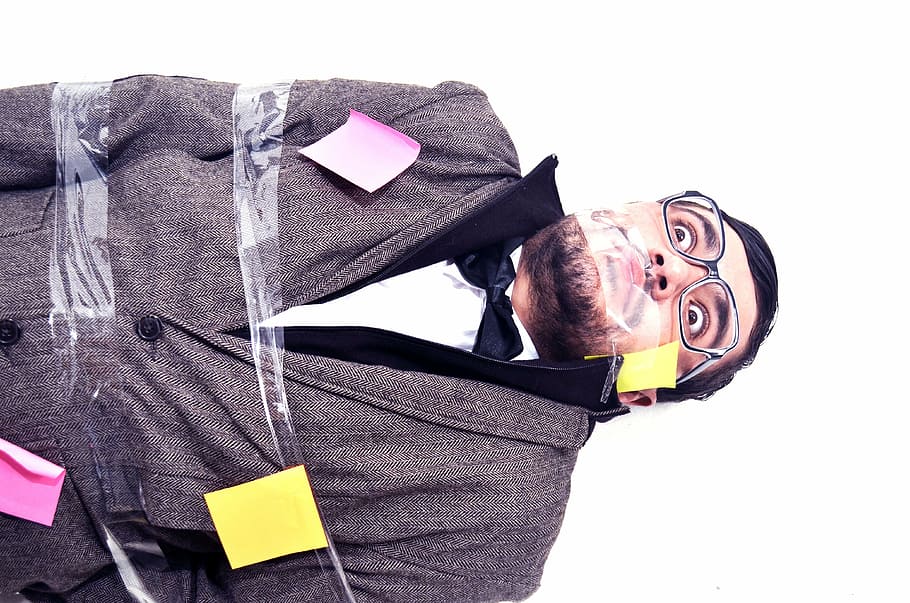 man covered with adhesive tape and sticky notes, disorder, women