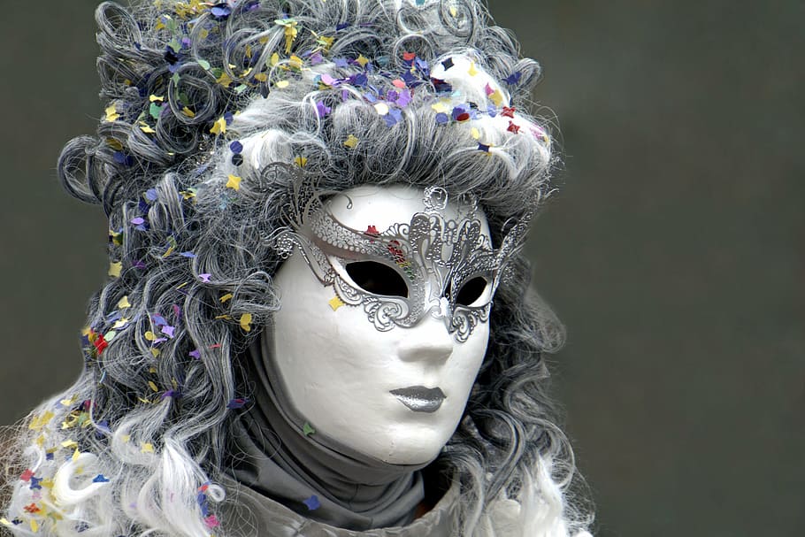 photo of person in white and gray mask and gray top, masquerade