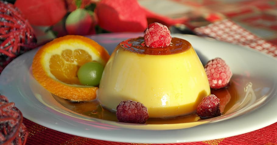 yellow pudding with red fruits, caramel, cream, flan, milk, egg