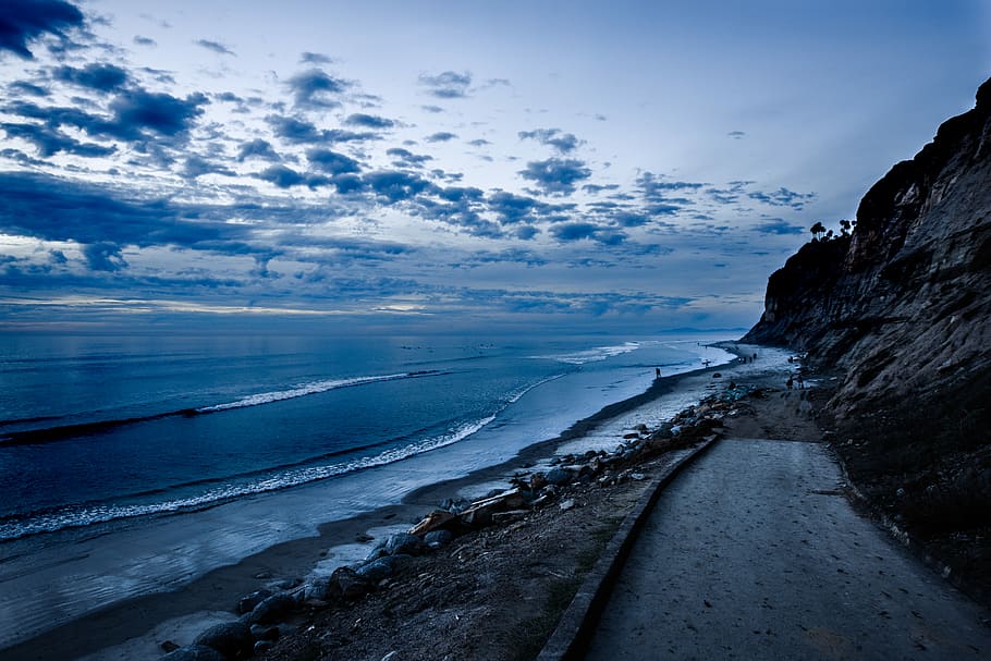 roadway near shoreline landscape photography, wave on beach under blue sky HD wallpaper